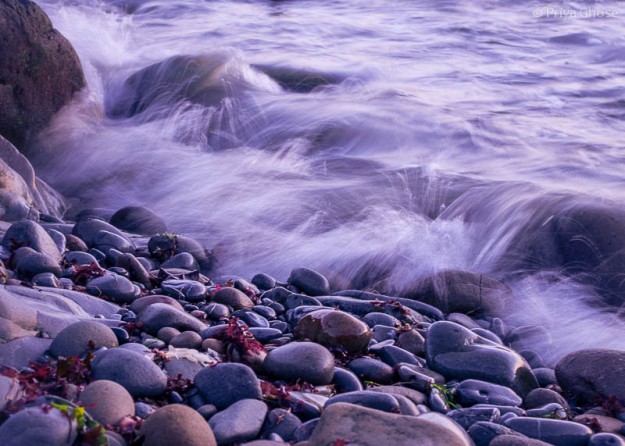 Ocean waves splash on rocks